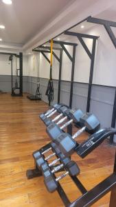 a gym with a row of dumbbells in a room at MONOAMBIENTE VILAUT Temporario in Córdoba