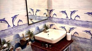 a bathroom with a sink and a mirror at Dee Dash Inn in Bhubaneshwar +82 photos