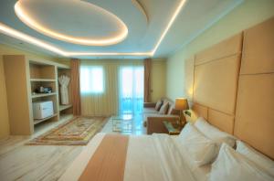 a hotel room with a bed and a living room at The Segond Hotel in Xagħra