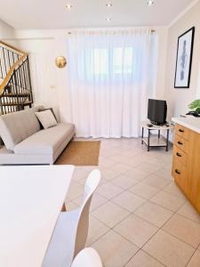 a living room with a couch and a tv at Apartment Relax & Wine in Novigrad Istria