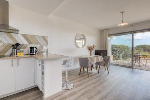 une cuisine et une salle à manger avec une table et des chaises dans l'établissement Peaceful Retreat with Stunning Sea View Private Terrace & Garden, au Lavandou
