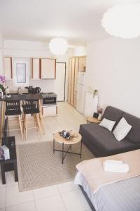 a living room with a couch and a kitchen at Ιasonas Apartment in Nafplio