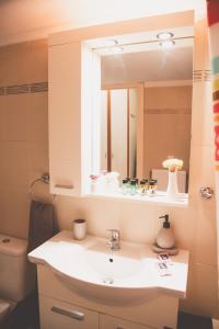 a bathroom with a sink and a mirror at Ιasonas Apartment in Nafplio +21 photos