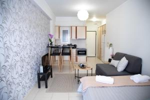 a living room with a couch and a kitchen at Ιasonas Apartment in Nafplio