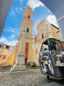 a building with a clock tower and a van in front of it at A Ca Du Barba Ge in Vallebona