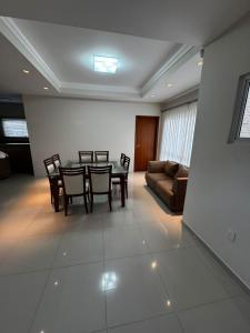 a living room with a table and chairs and a couch at Apto 2 in Florianópolis