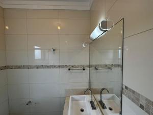a bathroom with a sink and a shower at Apto 2 in Florianópolis