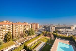 an aerial view of a building with a swimming pool at Giax Tower-Pool,Spa&Gym-Niguarda Hospital-10min to Duomo in Milan