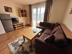 a living room with a couch and a table at Top Lodge twobedroom apartment in Bansko