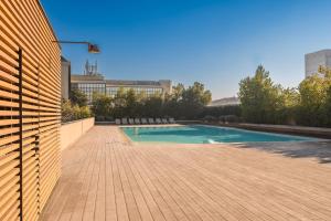 a swimming pool on top of a building at Giax Tower-Pool,Spa&Gym-Niguarda Hospital-10min to Duomo in Milan