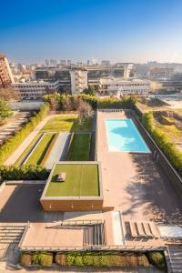 an overhead view of a pool with a tennis court at Giax Tower-Pool,Spa&Gym-Niguarda Hospital-10min to Duomo in Milan