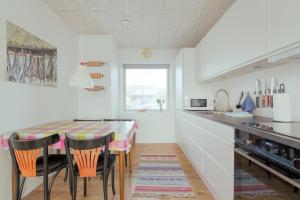 a kitchen with a table and chairs in a room at 1 BR Apartment - Tórshavn - Parking in Tórshavn