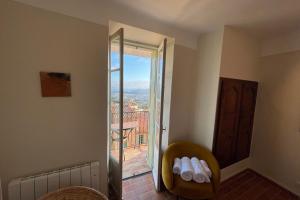 a room with a sliding glass door with a balcony at Charming Studio - in the heart of a medieval village in Bormes-les-Mimosas