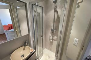 a shower in a bathroom with a toilet and a sink at Charming Studio - in the heart of a medieval village in Bormes-les-Mimosas +1 photo