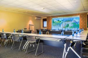 a conference room with tables and chairs and a large screen at Villa Mandhari - Diani Beach in Diani Beach +34 photos