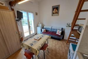 a room with a table and a bed in it at Family apartment - beach access swimming pool in Le Lavandou