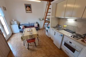 a small kitchen with a table and a table and chairs at Family apartment - beach access swimming pool in Le Lavandou