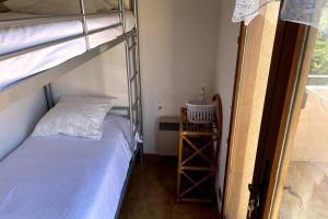a bedroom with a bunk bed and a ladder to a bunk bed at Family apartment - beach access swimming pool in Le Lavandou