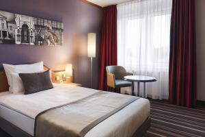Voodi või voodid majutusasutuse Leonardo Hotel Weimar toas