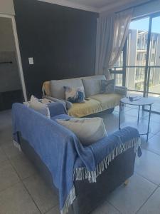 a living room with a couch and a table at Millennial Arch in Langebaan