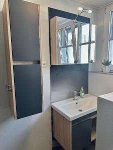 a bathroom with a sink and a mirror at Große Post in Schleiden