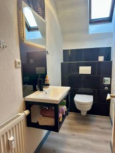 a bathroom with a sink and a toilet at Große Post in Schleiden