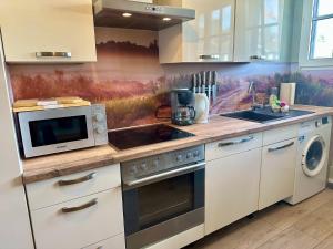 a kitchen with a microwave and a stove top oven at Große Post in Schleiden