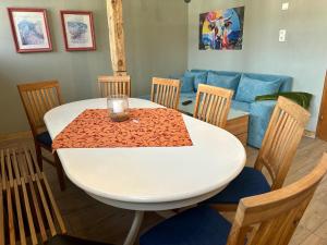 a table and chairs with a white table and a couch at Große Post in Schleiden +10 photos