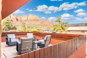 a balcony with chairs and a view of the mountains at The Redrock Experience with Mtn Views & Hottub in Sedona