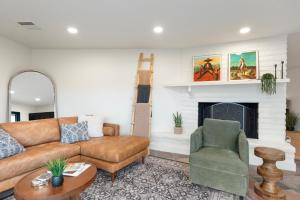 a living room with a couch and a chair at The Redrock Experience with Mtn Views & Hottub in Sedona +39 photos