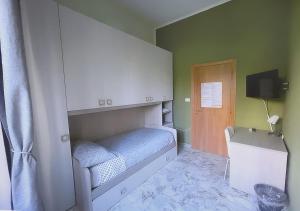 a small bedroom with a bed and a tv at Mi casa tu casa - Guest House in Catania