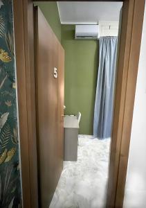 an open door to a bathroom with a toilet at Mi casa tu casa - Guest House in Catania +55 photos