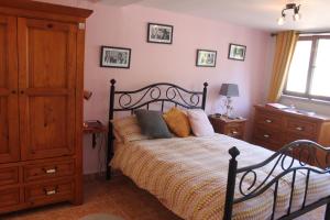 a bedroom with a bed and a dresser at Villa Tranquilla apartment in Oliveira do Hospital +54 photos