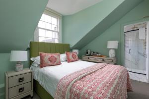 a bedroom with a bed and two night stands and a window at The Broughton Townhouse in Edinburgh