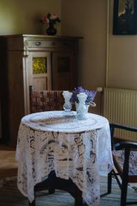 a table with two vases and flowers on it at Pension und Gastwirtschaft Mareile am Rennsteig in Rodacherbrunn