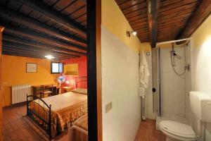 a bedroom with a bed and a bathroom with a shower at Casale Drinzi in Collesano