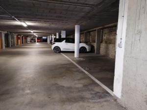a white car parked in an empty parking lot at Appartement centre ville avec parking privatif in Dijon
