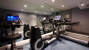 a gym with a bunch of exercise bikes and a mirror at Malmaison London in London