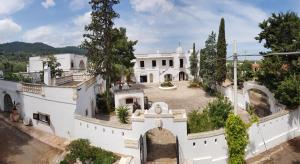an aerial view of a white mansion with a courtyard at Masseria Don Sante in Fasano