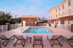 a patio with chairs and a swimming pool at Holiday Inn Express Pembroke by IHG in Pembroke