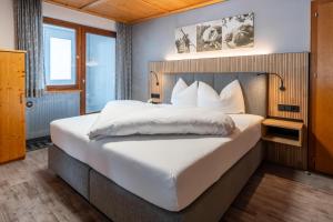 Posteľ alebo postele v izbe v ubytovaní Hotel Garni Madrisa