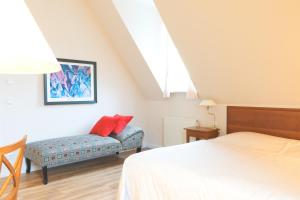 a bedroom with a bed and a chair at Hotel Villa Viktoria Luise in Blankenburg