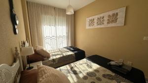 a bedroom with two beds and a window at Apartament GECO - near the beach in Lo Pagan in San Pedro del Pinatar