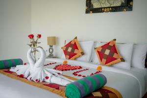 A bed or beds in a room at The Wise Ubud