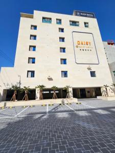 a large building with a sign on it at Daisy hotel in Tongyeong