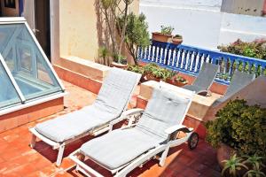 a pair of chairs sitting on a patio at Sublime Riad d'artiste au coeur de la médina d'Essaouira in Essaouira