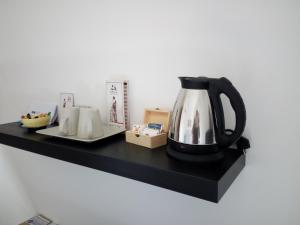 a black shelf with a tea kettle on it at L'Altra Modica Locazione Turistica in Modica