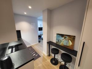 a kitchen with a counter top and a painting on the wall at Kolonaki Studio in Athens