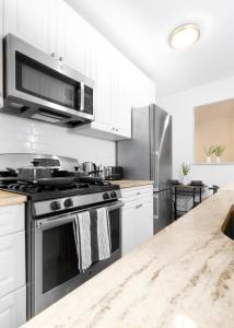 a kitchen with a stove and a refrigerator at Beachh - Ocean Stay - Blue3090 in Brooklyn