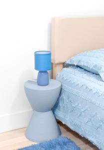 a blue lamp sitting on top of a toilet next to a bed at Beachh - Ocean Stay - Blue3090 in Brooklyn